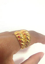 Load image into Gallery viewer, Gold  ribbed ring on a finger against a white background
